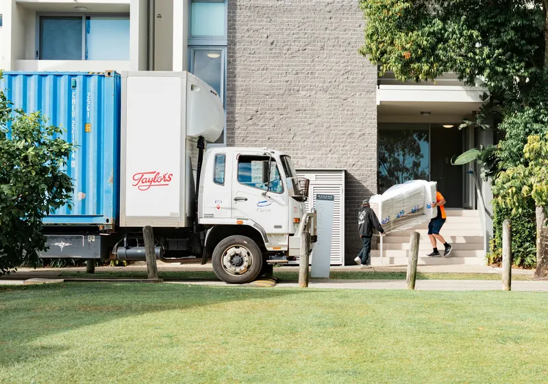 Movers unloading furniture from a truck