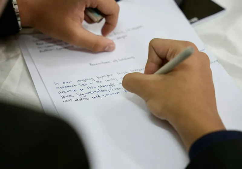 A candidate writing an essay by hand
