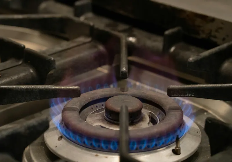 A blue flame on a gas stove burner
