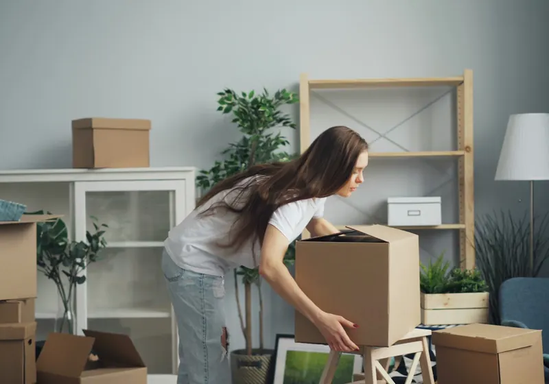A woman packing cardboard boxes before a move