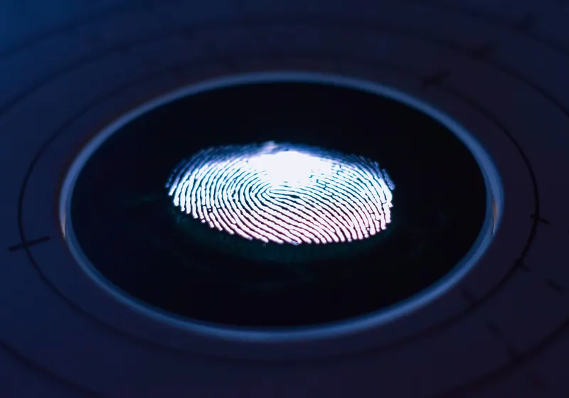 A glowing fingerprint on a biometric scanner